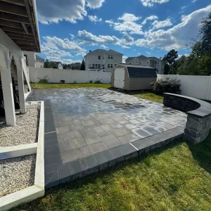 Dark grey patio with seating area in Maryland backyard on a sunny day