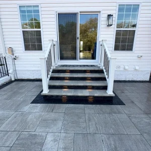 Grey and black stone staircase going from house to back patio