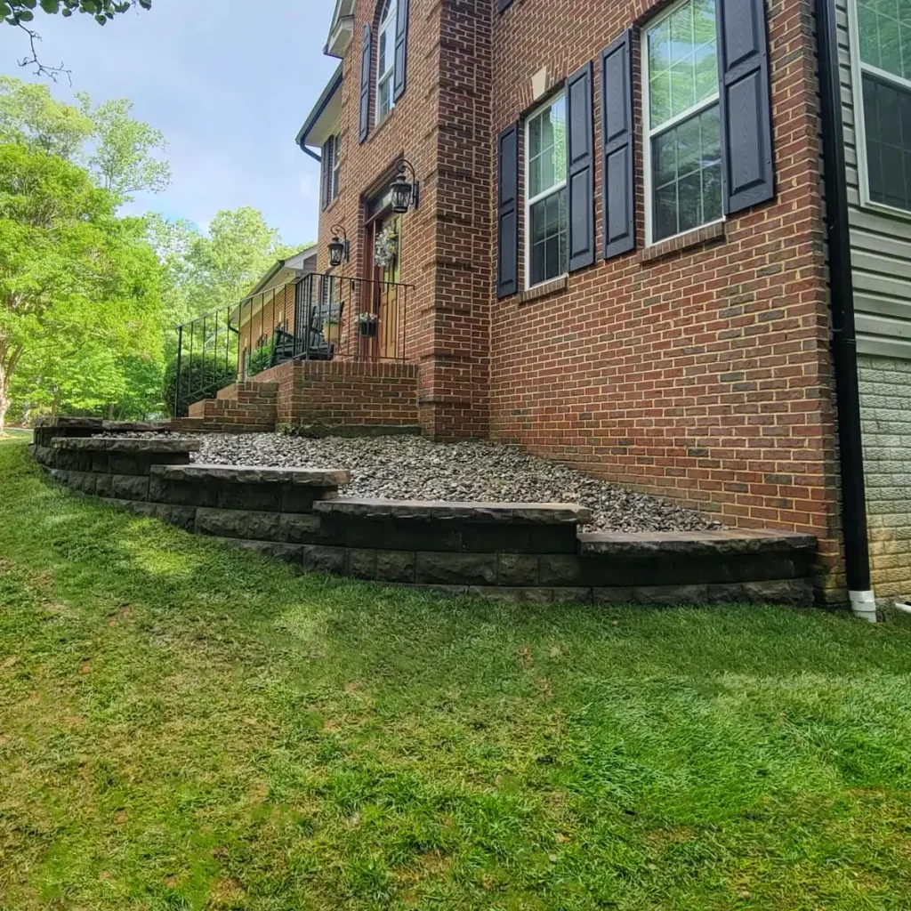 Landscaping lawn and planters next to brick house in Maryland