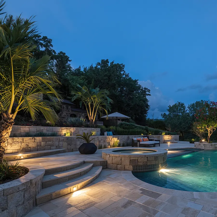 Fancy pool and patio area at night with built in lighting for swimming in the dark